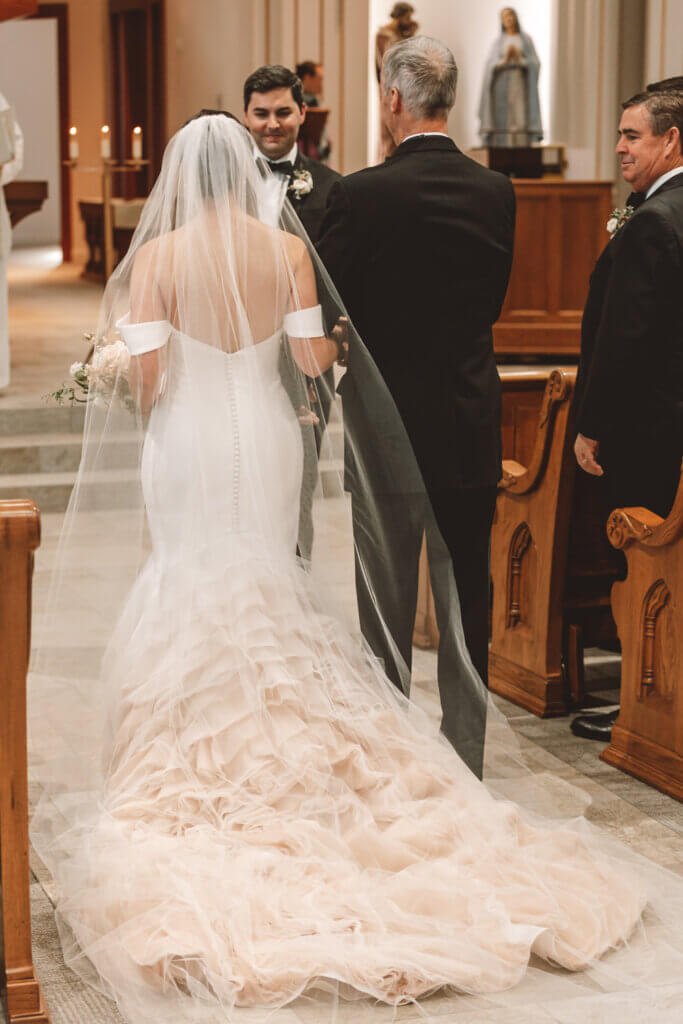 Bride and Groom standing at alter at the Holy Rosary Catholic Church during their fall wedding in Bozeman, MT.