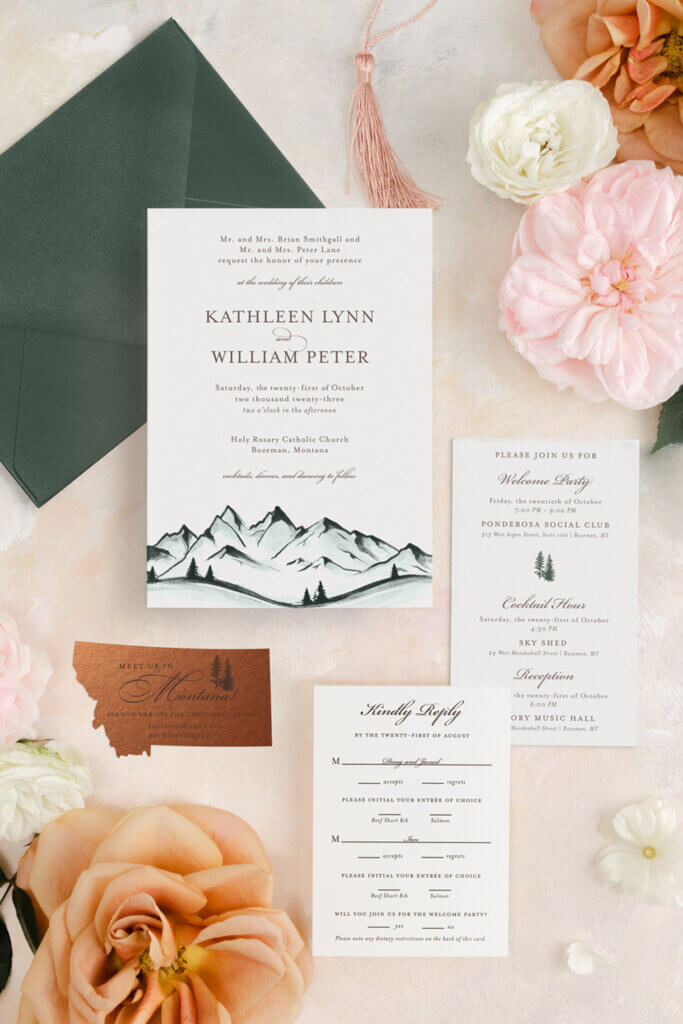 A Montana fall wedding invitation with a mountain scene and metallic copper Montana die-cut card.