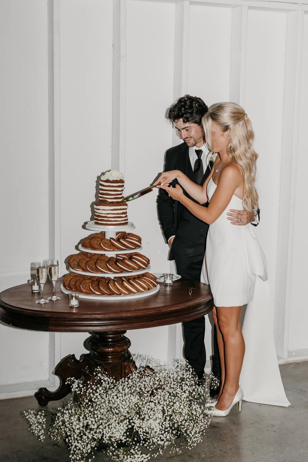 Black and White Wedding Invitations for a Classic Ashford Acres Inn Wedding 40 Audrey and Nathaniel cutting their cookie tower wedding cake at Ashford Acres Inn.