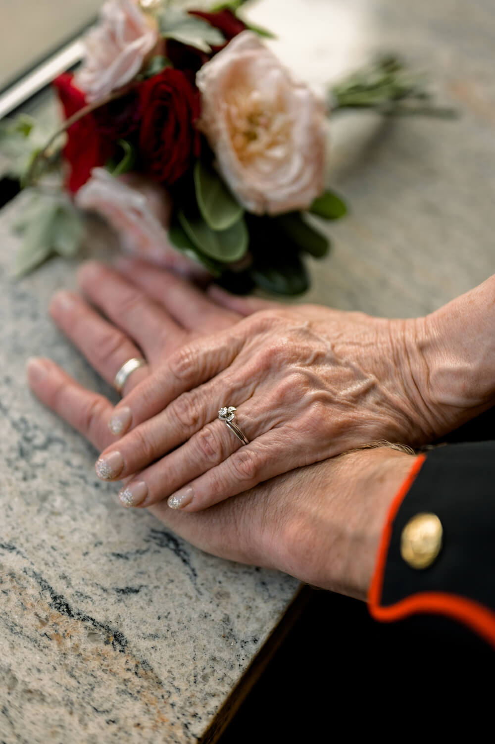 Celebrating 50 Years of Love: Our Parents' Golden Anniversary 43 Close-up of the couple’s hands resting together, showcasing their wedding rings after 50 years of marriage