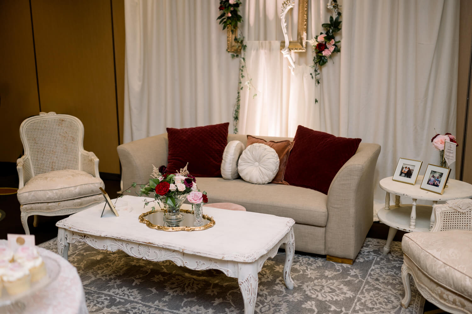 Celebrating 50 Years of Love: Our Parents' Golden Anniversary 9 Lounge area for a 50th wedding anniversary, featuring vintage furniture, floral arrangements, and a Victorian-inspired backdrop