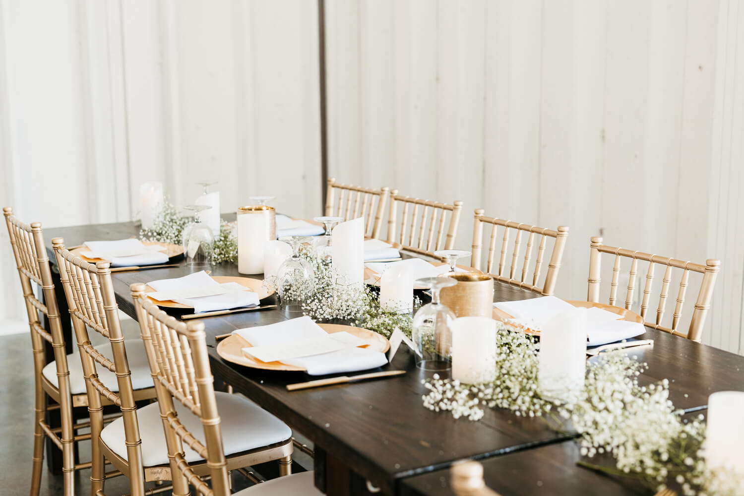 Black and White Wedding Invitations for a Classic Ashford Acres Inn Wedding 20 Reception table styled with black and white menus, gold chargers, baby's breath runners, and candlelight, paired with gold chairs.