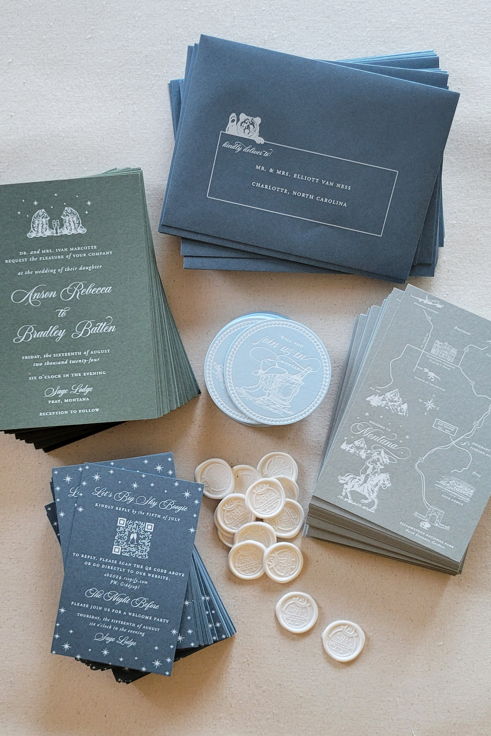Guide to Luxury Wedding Invitations: What Makes Them Different & Why They Matter 2 Complete wedding stationery suite arranged on linen, including invitations, envelopes, map cards, wax seals, and RSVP cards with illustrated details. The coordinated palette and cohesive design reflect a thoughtfully curated luxury wedding invitation experience.