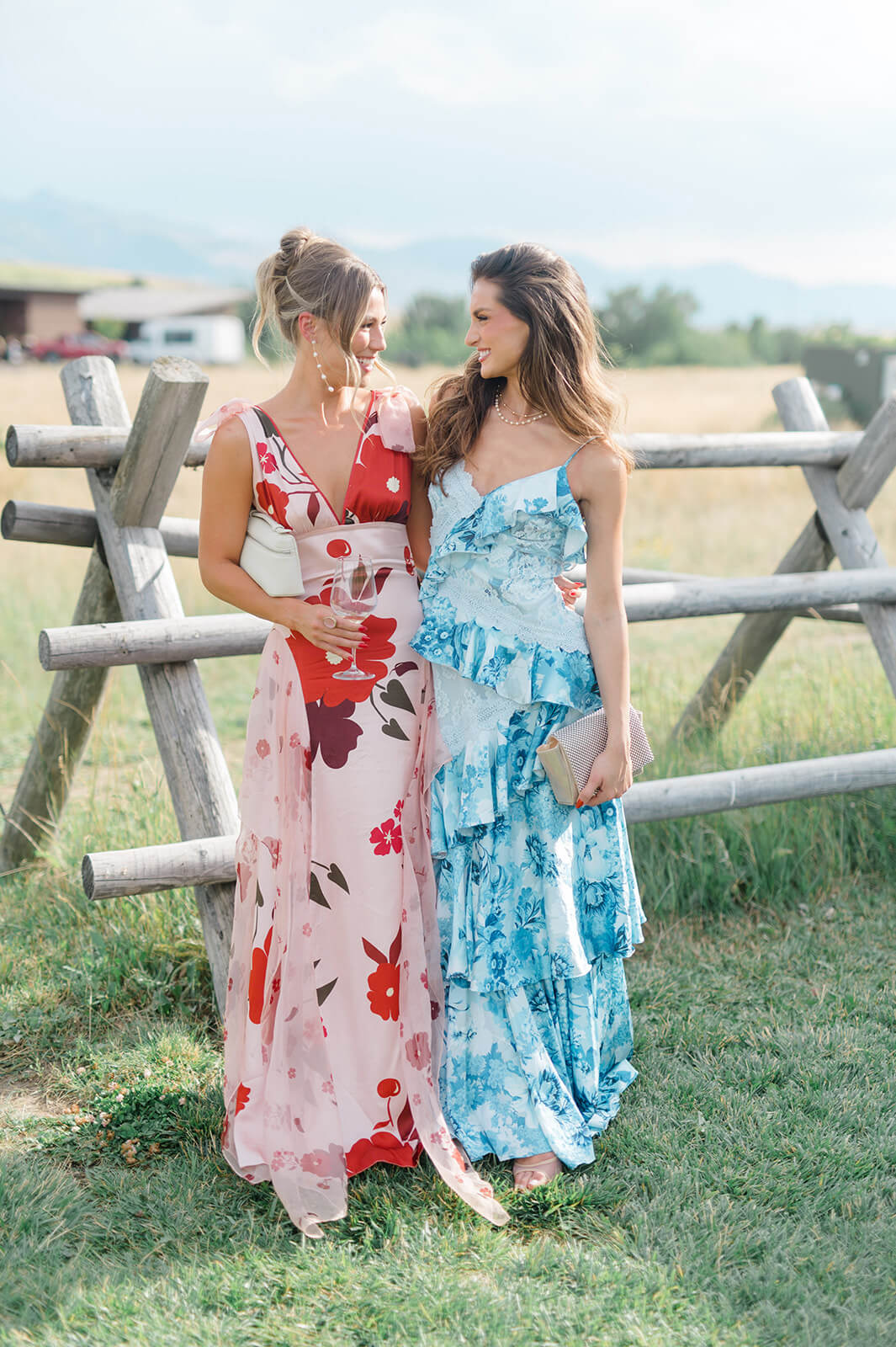 Wedding Dress Codes, Decoded 18 Wedding guests wearing a variety of dresses at an outdoor mountain wedding, showcasing modern wedding guest attire for a summer celebration.
